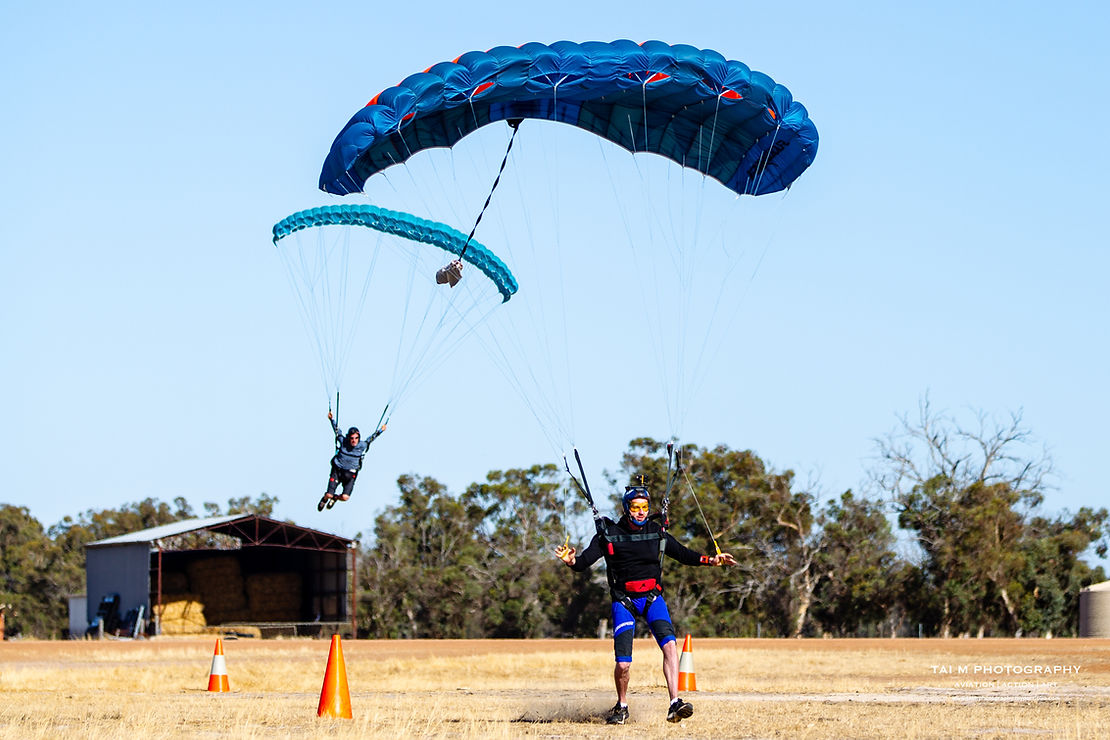 Two skydivers come in for a landing