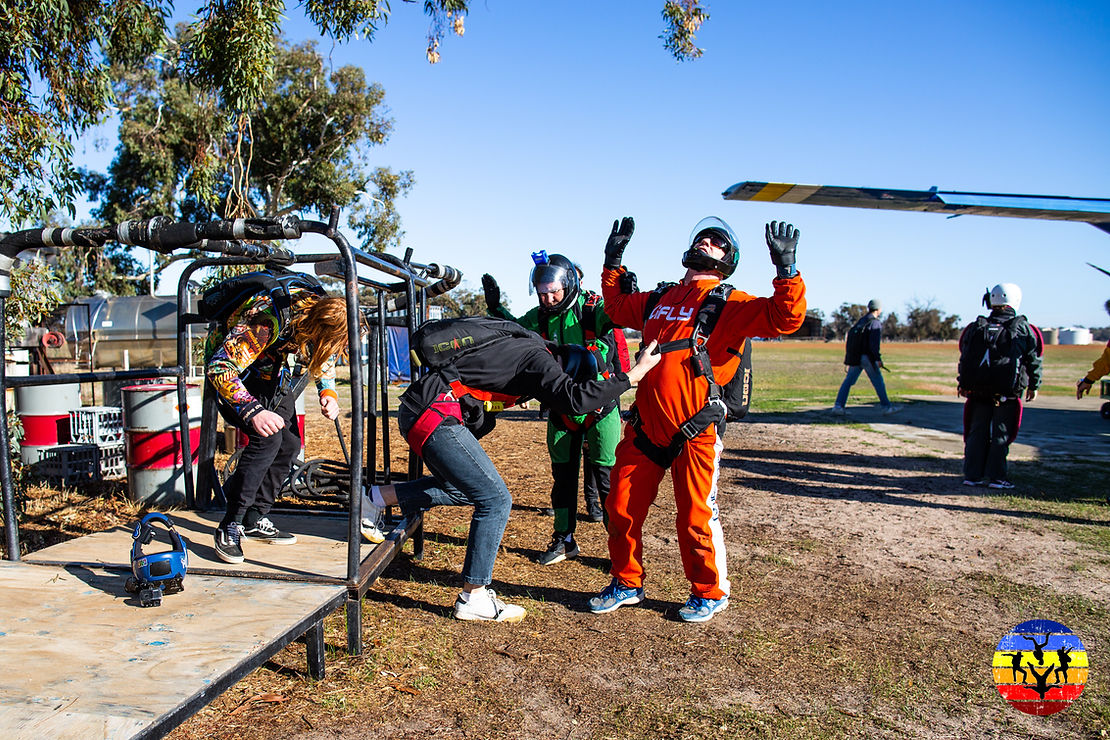 Skydivers practise their jump on the ground