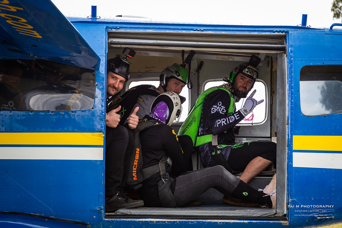 four skydivers get ready for take off