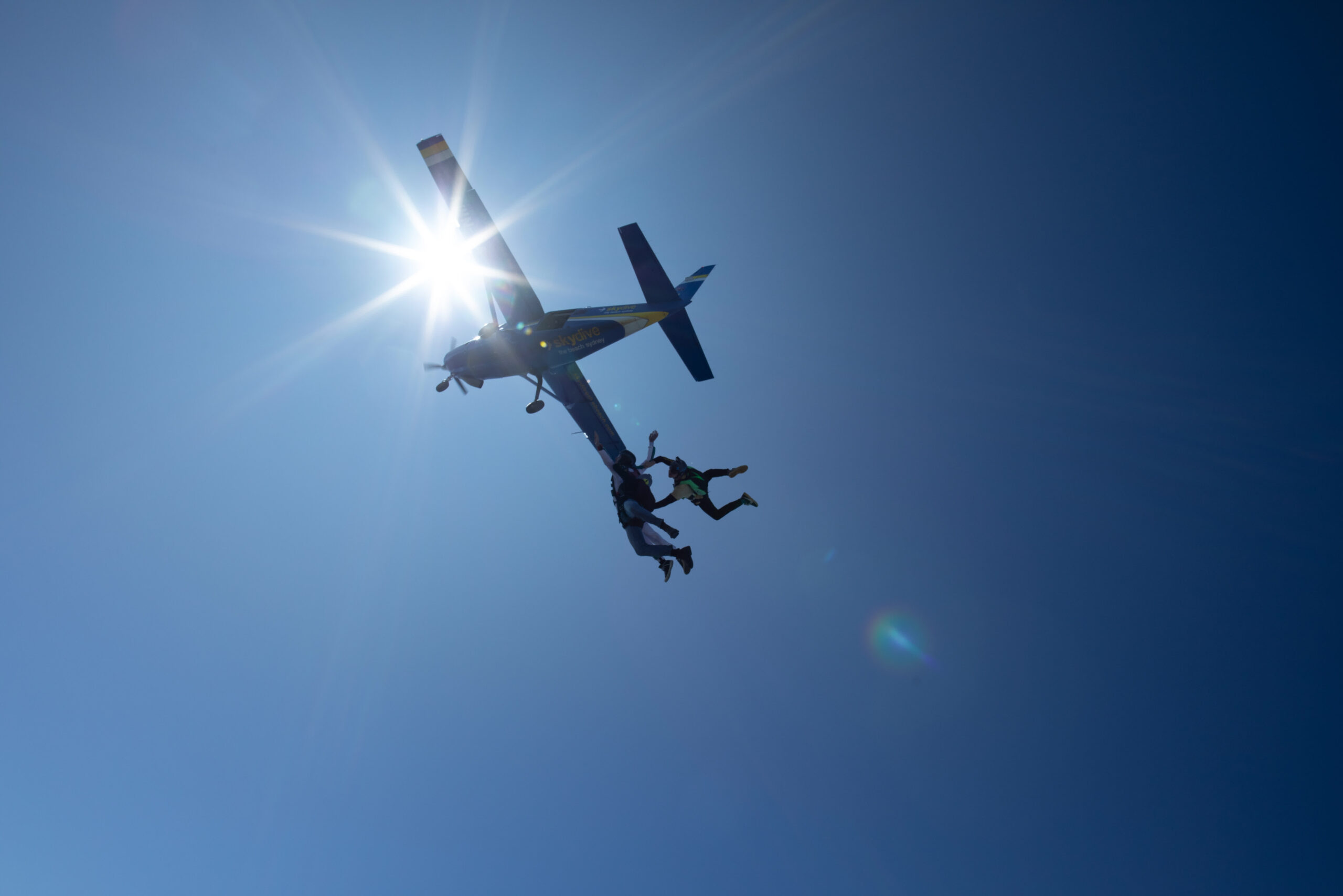 AFF Skydiving Exit – Learn to Skydive & Progress to Wingsuiting Skydiver exiting the plane during an AFF training jump – the first step toward solo skydiving and wingsuit flying.