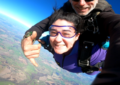 Tandem skydiver preparing to exit the aircraft with an instructor at The Skydive School in WA, ready for an unforgettable freefall experience