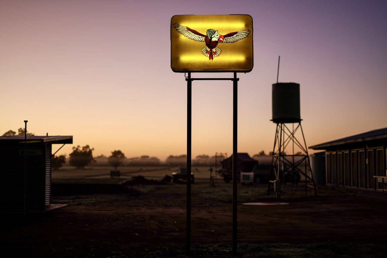 Sunset over the airfield sign and water tank at Hillman Farm, Darkan