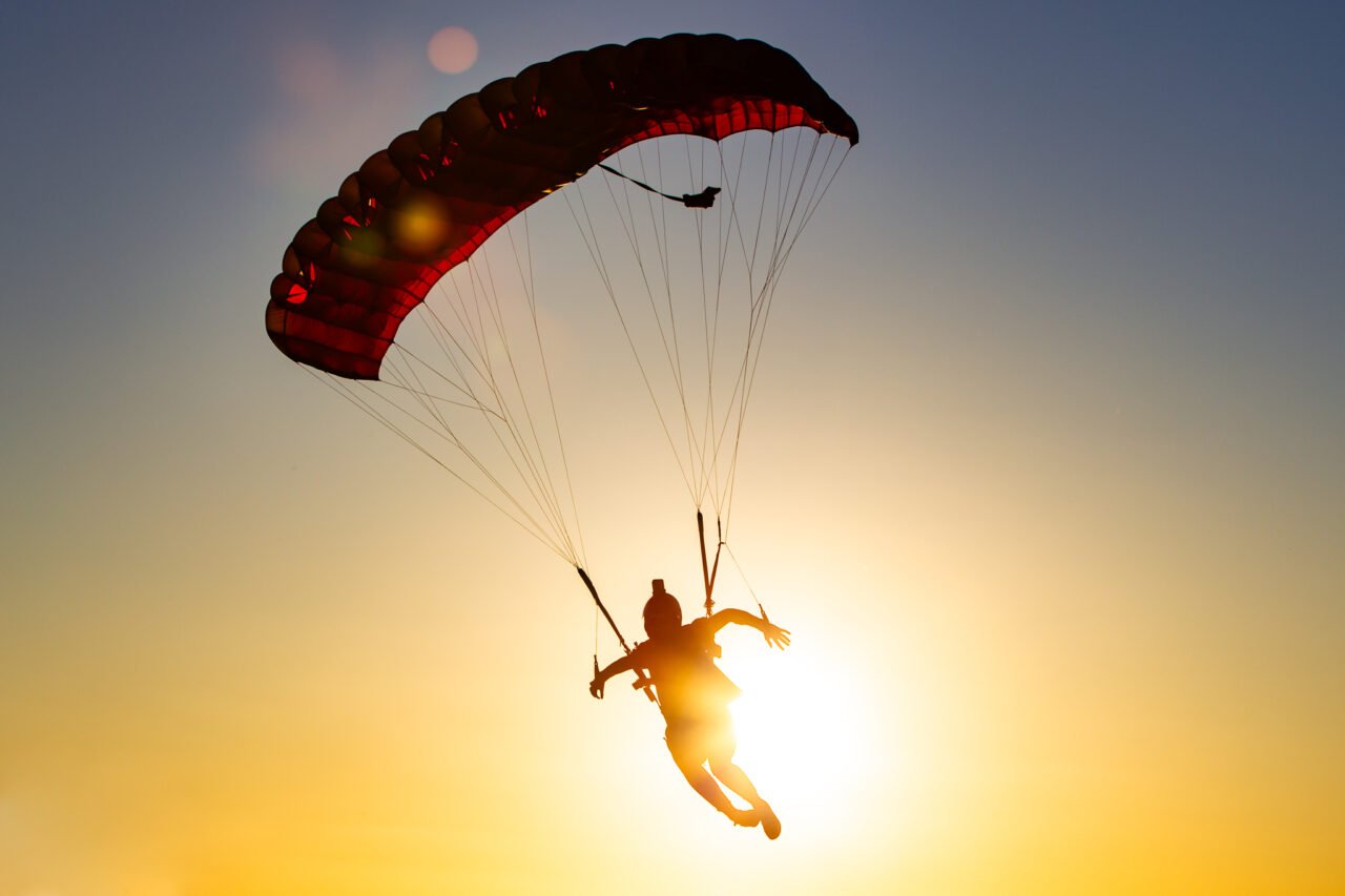 Skydiver steering a parachute towards the Hillman Farm landing area near Darkan at sunset