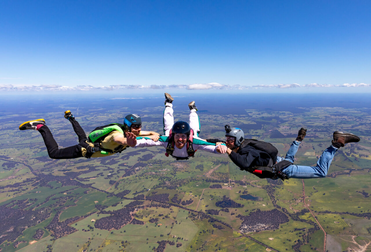 Skydiving from Perth 2 Skydivers in freefall high above the patchwork farmland of the Wheatbelt near Darkan
