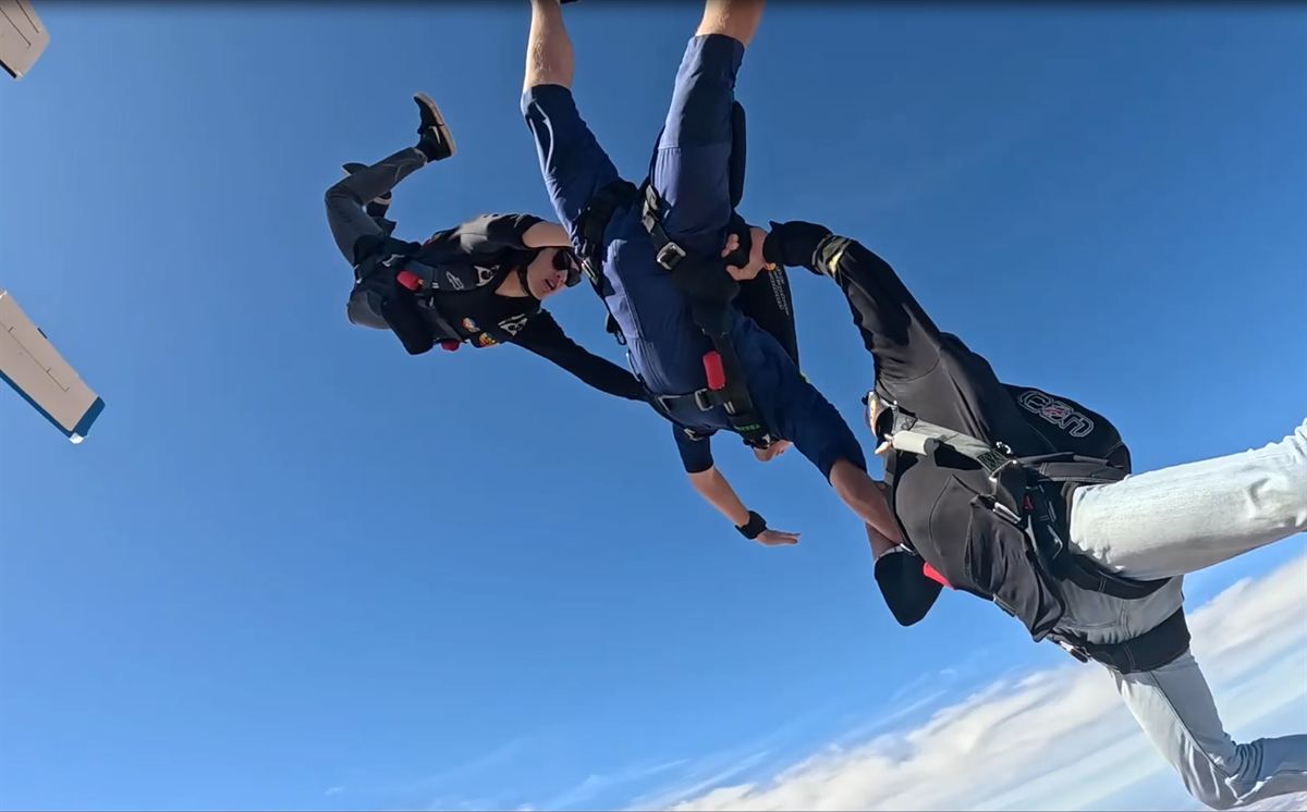Learn to Skydive – AFF Course (deposit) 4 Freefall skydivers against a blue WA sky