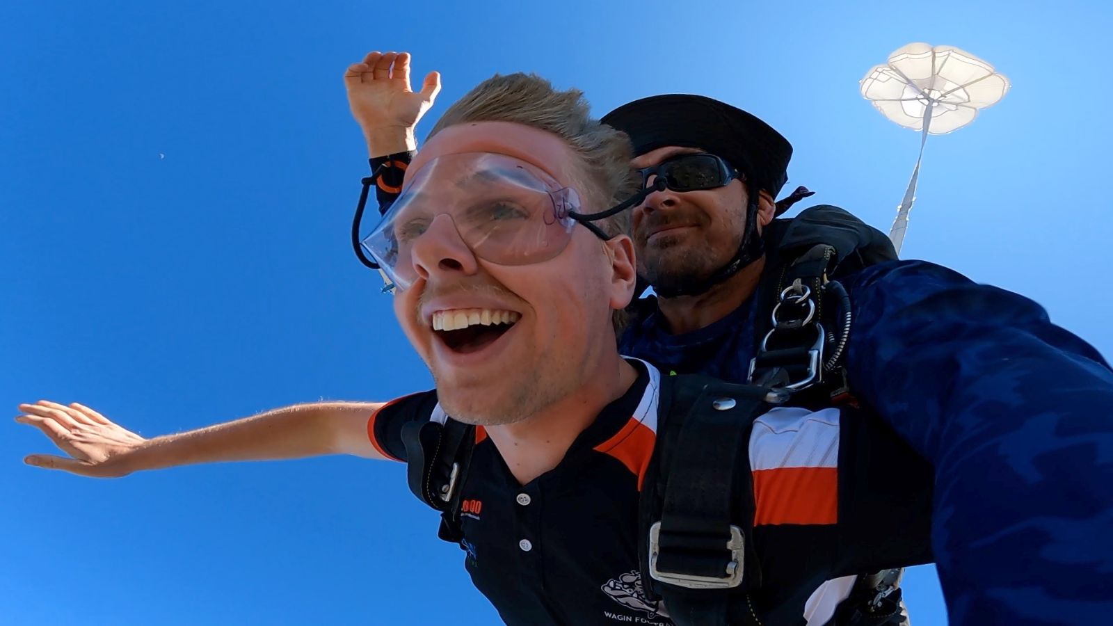 Where We Are 4 Tandem skydivers grinning in freefall over Western Australia