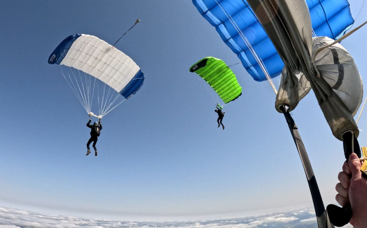 Parachutes open above the clouds in WA