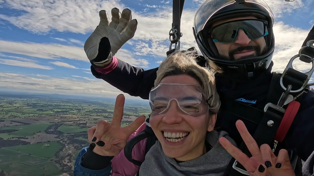 Skydiving from Perth 1 Tandem skydiver smiling under the parachute with her instructor, Wheatbelt farmland below near Darkan WA